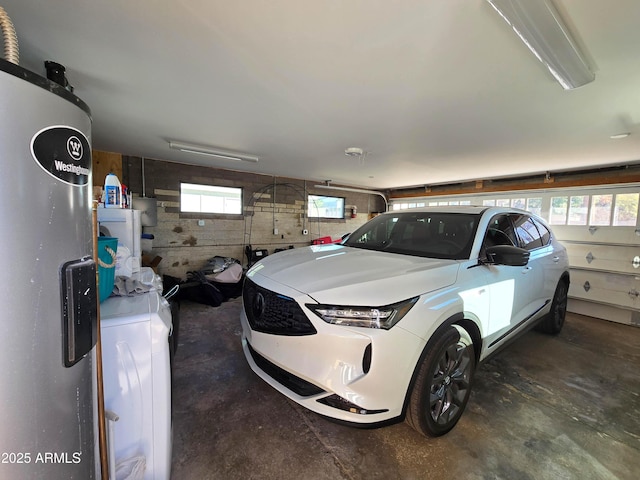 garage with washer / clothes dryer and electric water heater