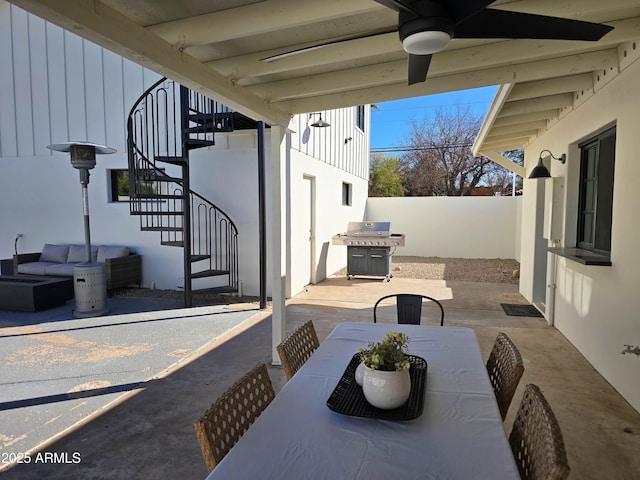 view of patio / terrace featuring outdoor dining area, outdoor lounge area, stairway, a grill, and fence