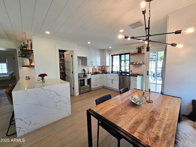 dining area featuring wood ceiling, light wood-style flooring, visible vents, and recessed lighting