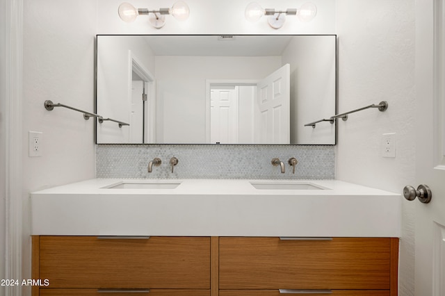 bathroom with decorative backsplash and vanity