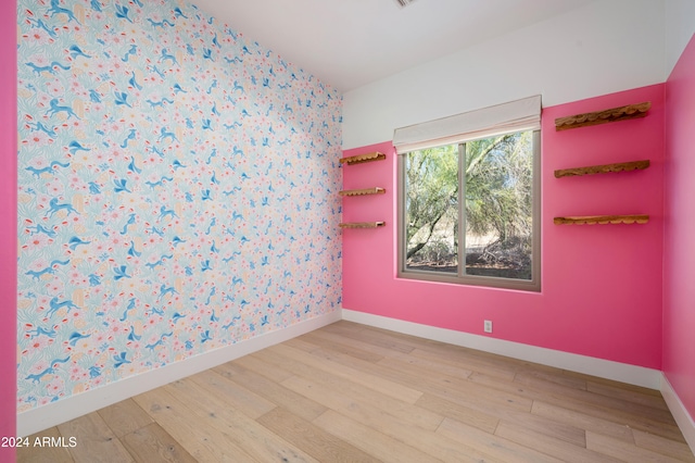 spare room with light wood-type flooring