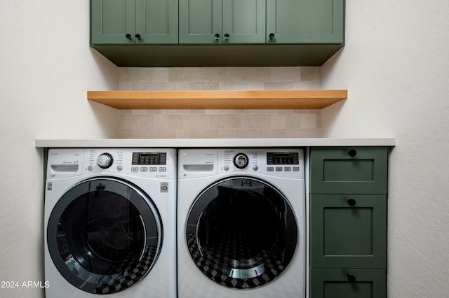 washroom with cabinets and washing machine and clothes dryer