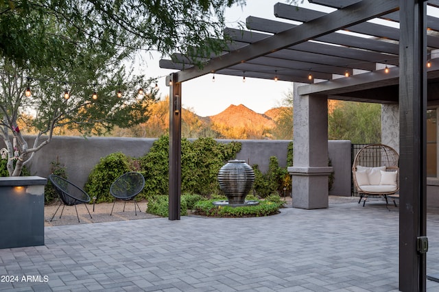 view of patio / terrace featuring a mountain view and a pergola