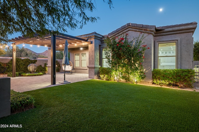 exterior space featuring a pergola, a front lawn, and a patio area