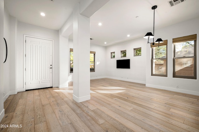 entryway with light hardwood / wood-style flooring and plenty of natural light