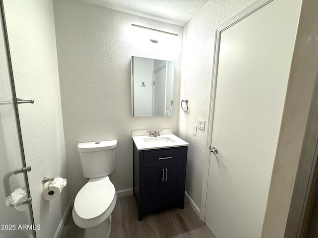921 W University Dr Unit 1038, Mesa, AZ 85201 - bathroom featuring wood finished floors, toilet, vanity, baseboards, and a textured wall