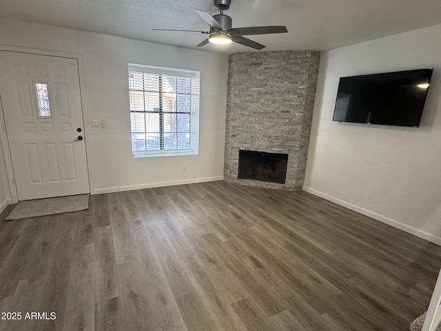 921 W University Dr Unit 1038, Mesa, AZ 85201 - unfurnished living room with a ceiling fan, wood finished floors, a stone fireplace, and baseboards