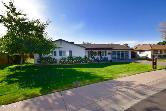 ranch-style home with a front yard and a garage