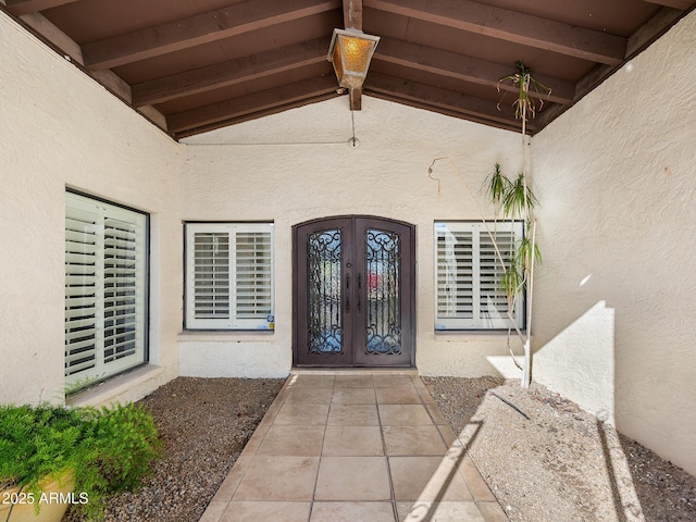 entrance to property with stucco siding and french doors