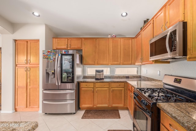 kitchen featuring appliances with stainless steel finishes and light tile patterned floors