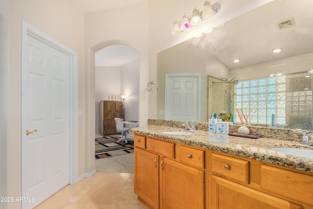 bathroom with vanity, a shower with shower door, and tile patterned floors