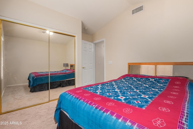 bedroom with lofted ceiling, carpet floors, and a closet