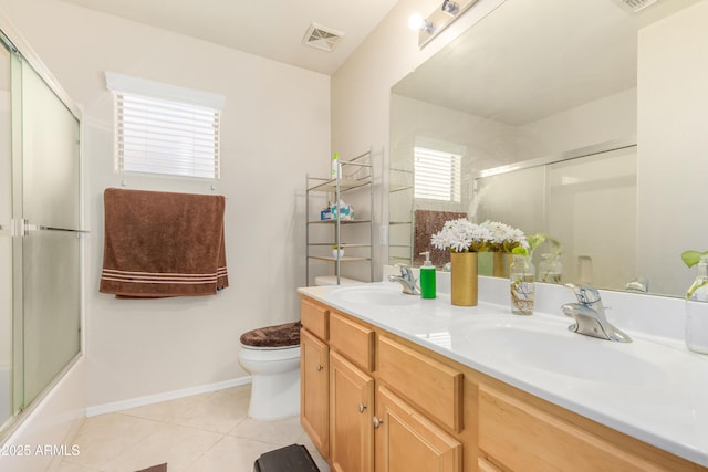 full bathroom featuring vanity, combined bath / shower with glass door, tile patterned floors, and toilet