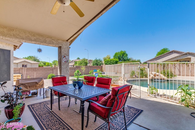 view of patio / terrace with a fenced in pool and ceiling fan