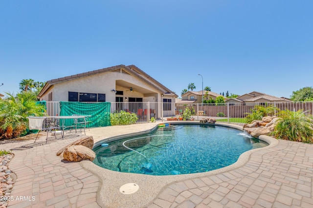 view of pool featuring pool water feature, ceiling fan, and a patio area