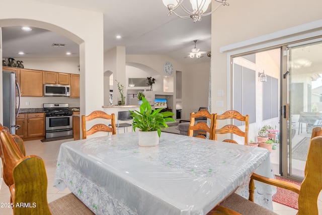 tiled dining space featuring ceiling fan and lofted ceiling