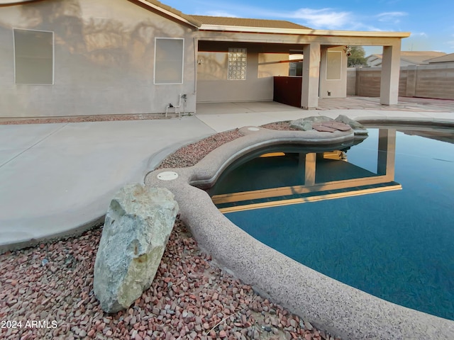 view of swimming pool with a patio area