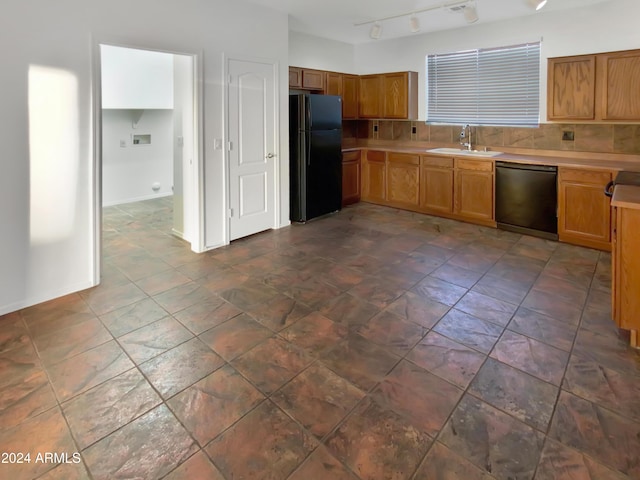 kitchen featuring decorative backsplash, sink, rail lighting, and black appliances