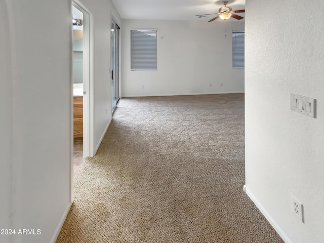 empty room with carpet flooring and ceiling fan