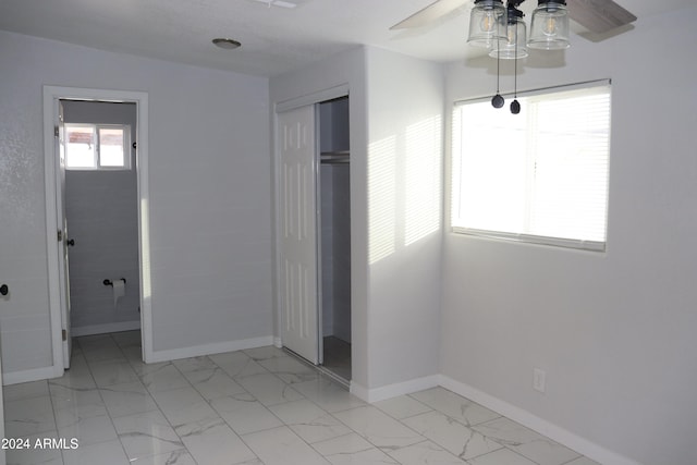 unfurnished bedroom with a closet and ceiling fan