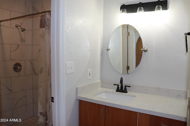 bathroom featuring vanity and curtained shower