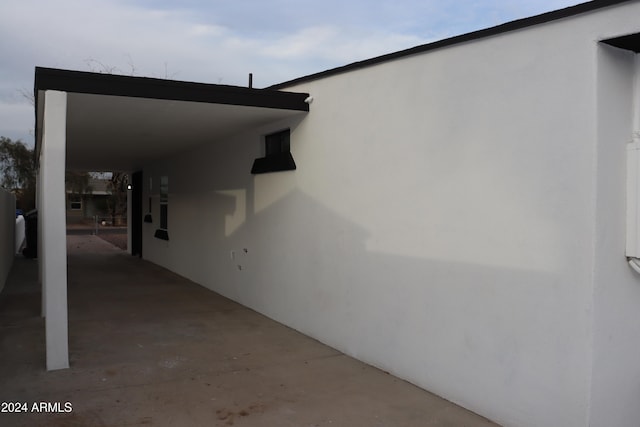 view of side of home featuring a carport