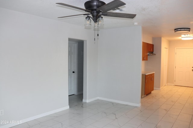 spare room featuring a textured ceiling and ceiling fan