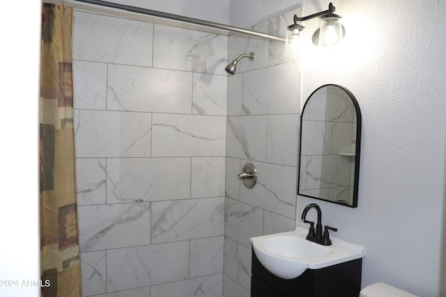 bathroom featuring vanity, curtained shower, and toilet