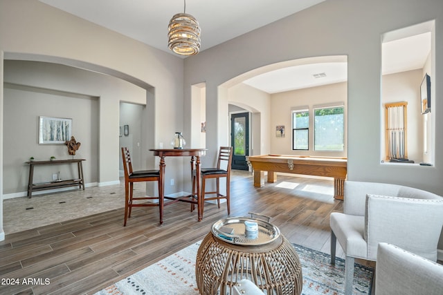 living room featuring hardwood / wood-style floors and pool table