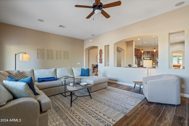 living room with dark hardwood / wood-style floors and ceiling fan