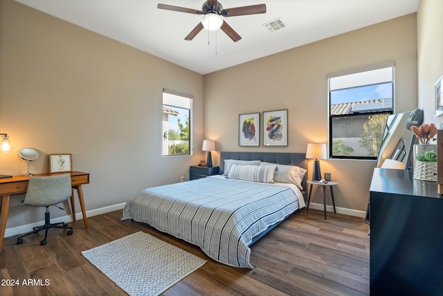 bedroom with dark hardwood / wood-style flooring and ceiling fan