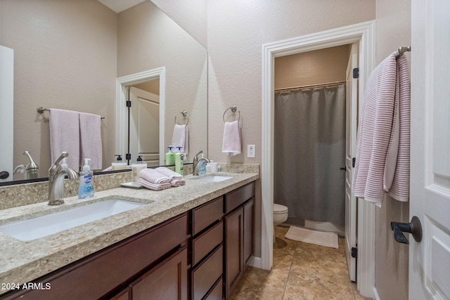 bathroom with tile patterned floors, vanity, and toilet