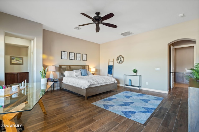 bedroom with dark hardwood / wood-style floors and ceiling fan