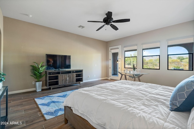 bedroom with ceiling fan and dark wood-type flooring