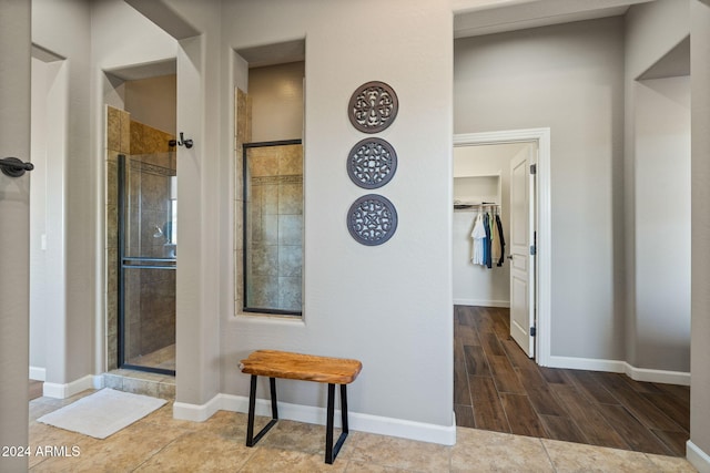 corridor featuring dark tile patterned flooring