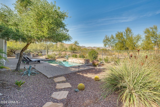 exterior space with a mountain view and a patio