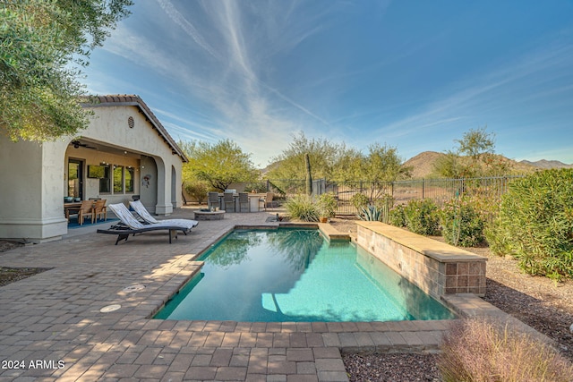 view of pool with a patio area and a mountain view