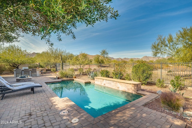 view of swimming pool with a mountain view and a patio