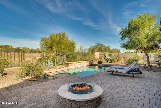 view of pool with a patio and an outdoor fire pit