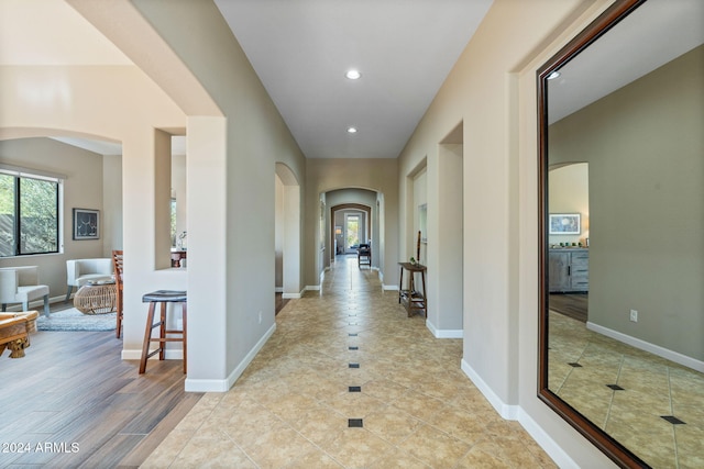 corridor with light wood-type flooring