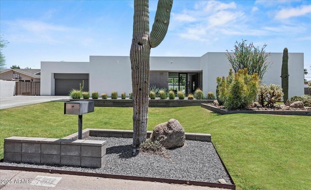 5301 N 43rd St, Phoenix, AZ 85018 - contemporary house with concrete driveway, stucco siding, an attached garage, and a front lawn