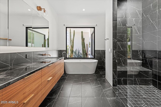 5301 N 43rd St, Phoenix, AZ 85018 - bathroom with tile walls, a freestanding bath, vanity, marble finish flooring, and recessed lighting