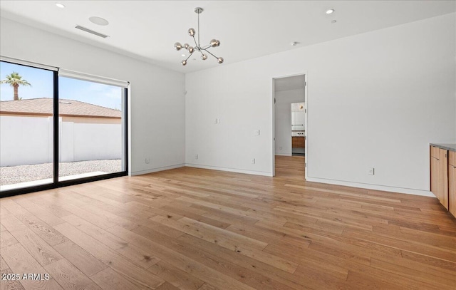5301 N 43rd St, Phoenix, AZ 85018 - unfurnished room featuring a chandelier, light wood-style flooring, and recessed lighting