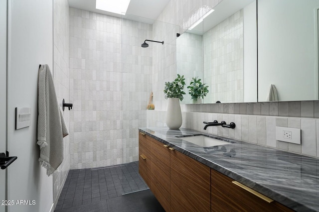 5301 N 43rd St, Phoenix, AZ 85018 - bathroom with tile walls, vanity, tile patterned floors, tiled shower, and backsplash