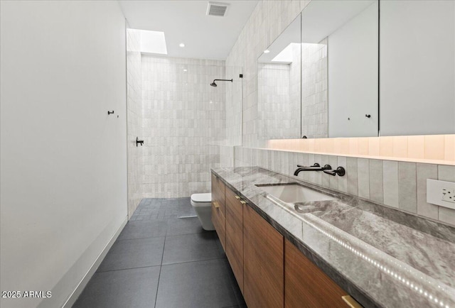 5301 N 43rd St, Phoenix, AZ 85018 - full bathroom featuring vanity, tiled shower, tile patterned flooring, and tile walls