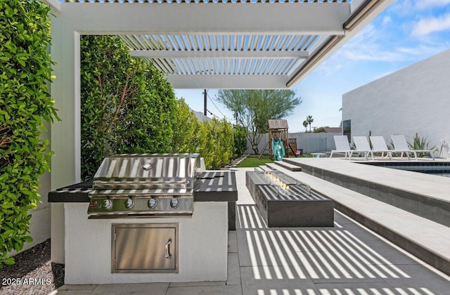 5301 N 43rd St, Phoenix, AZ 85018 - view of patio featuring an outdoor fire pit, exterior kitchen, and a playground