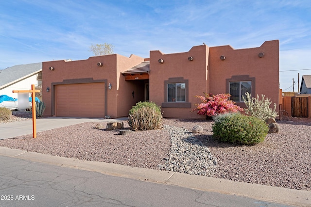 pueblo-style house with a garage