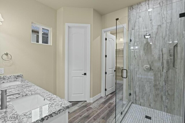 1910 E Rainbow Trl, Payson, AZ 85541 - bathroom featuring double vanity, a stall shower, a sink, and wood finished floors