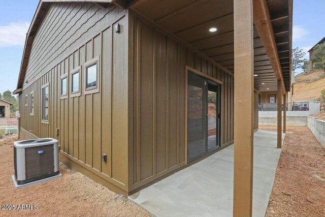 1910 E Rainbow Trl, Payson, AZ 85541 - view of property exterior featuring a patio, board and batten siding, and cooling unit