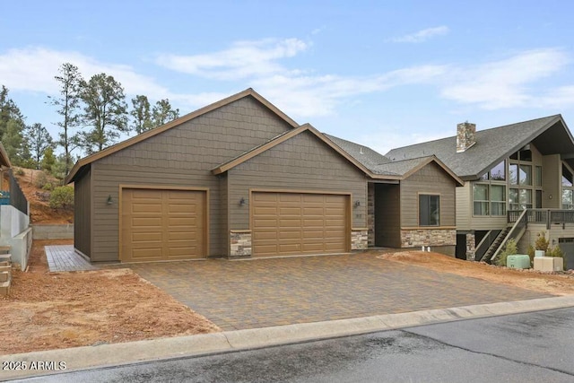 1910 E Rainbow Trl, Payson, AZ 85541 - view of front of property with a chimney, stone siding, decorative driveway, and an attached garage